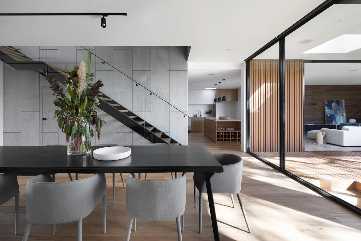 Remodeled open living space with large black-framed windows